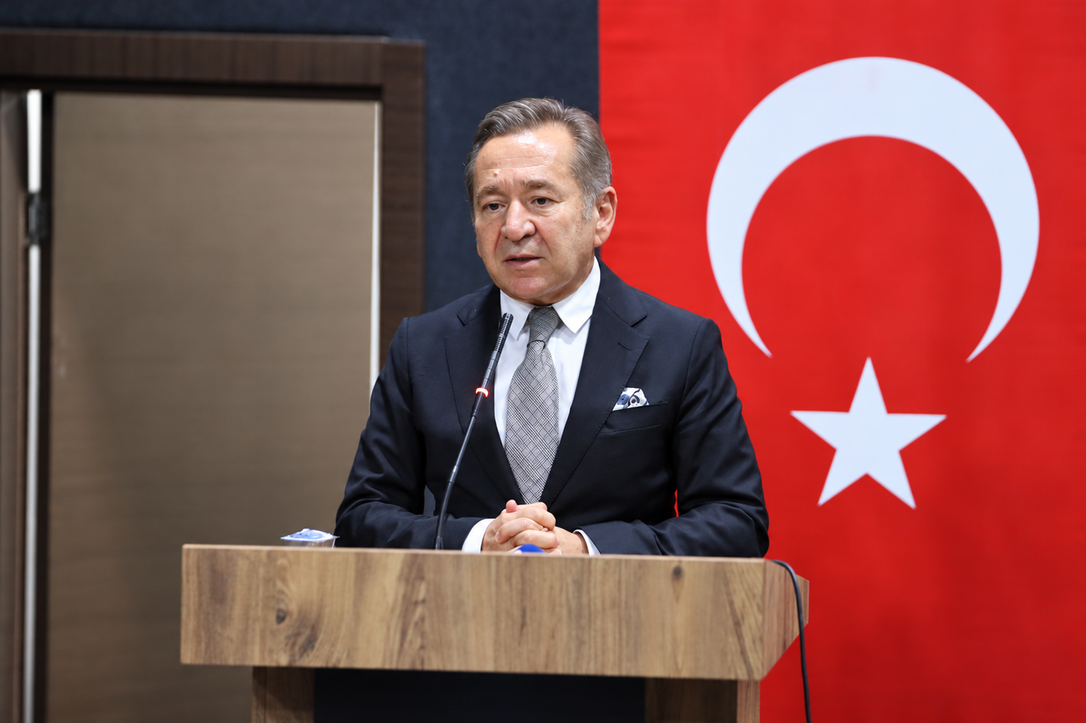 Speaker at lectern with turkish flag