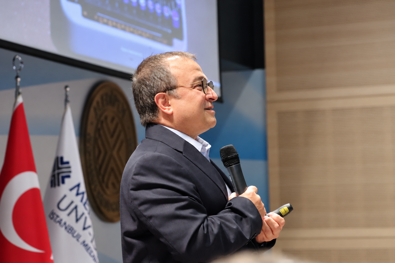 University speaker with turkish flags