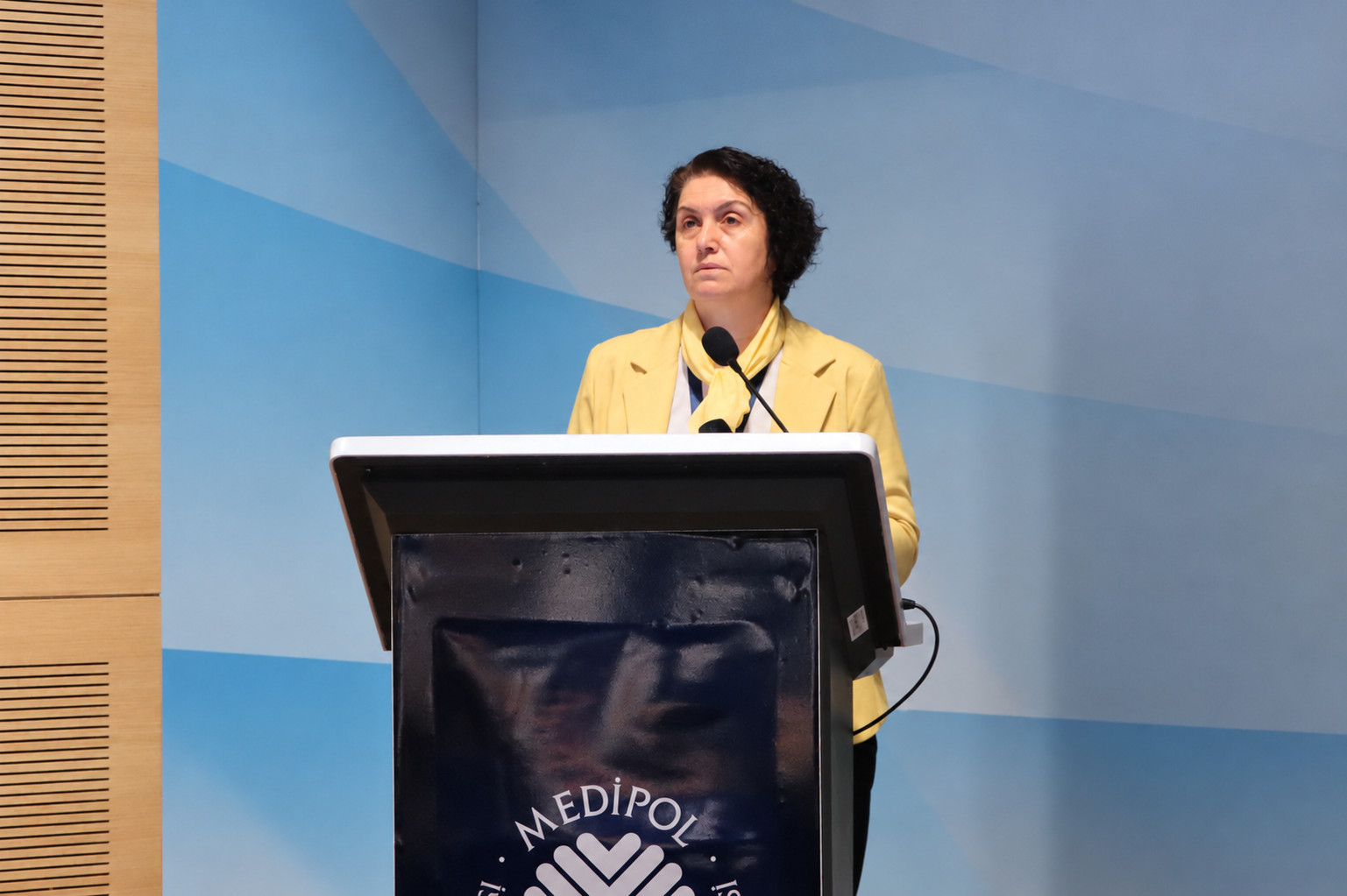 Woman speaking at a university lectern