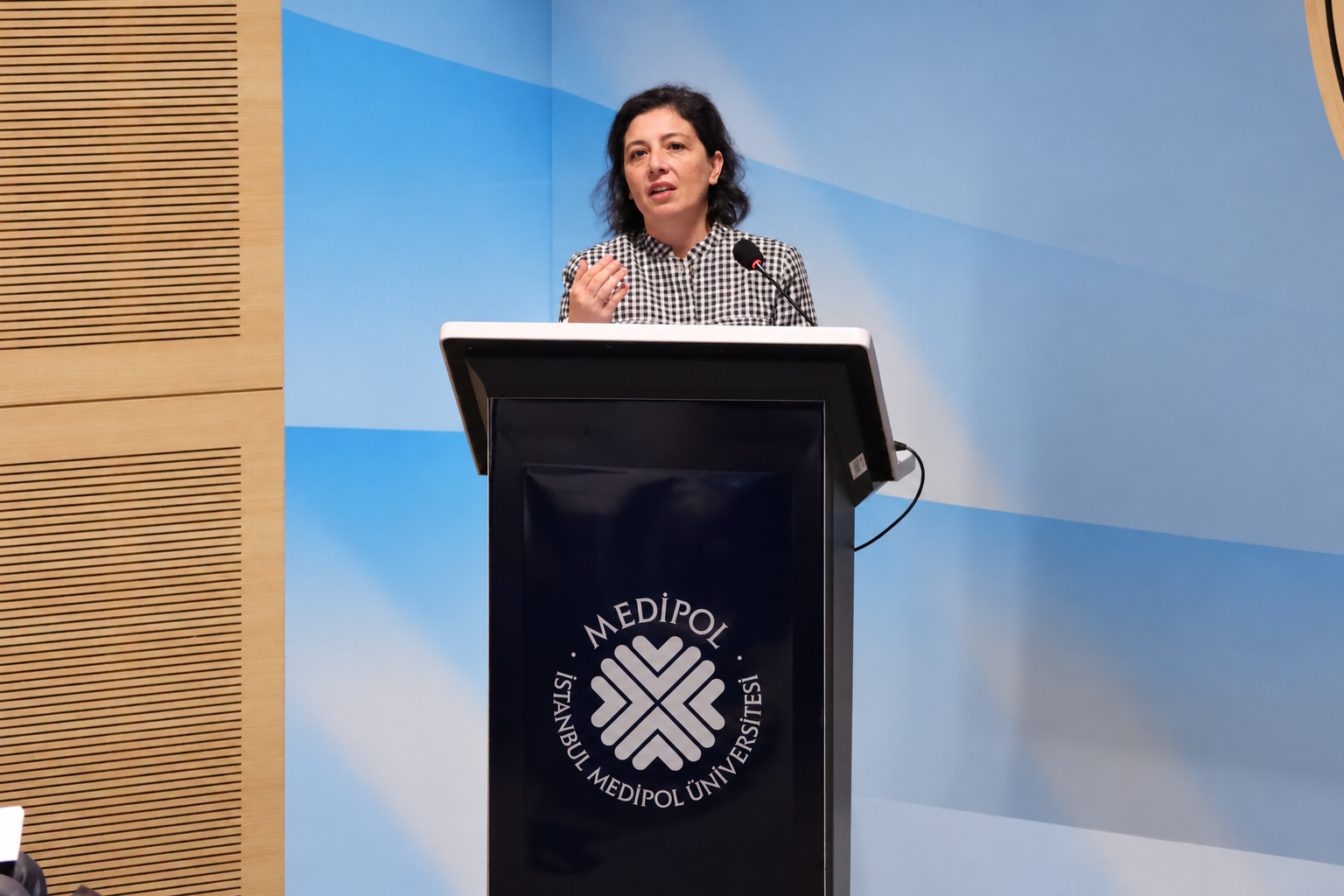 Woman speaking at a university lectern