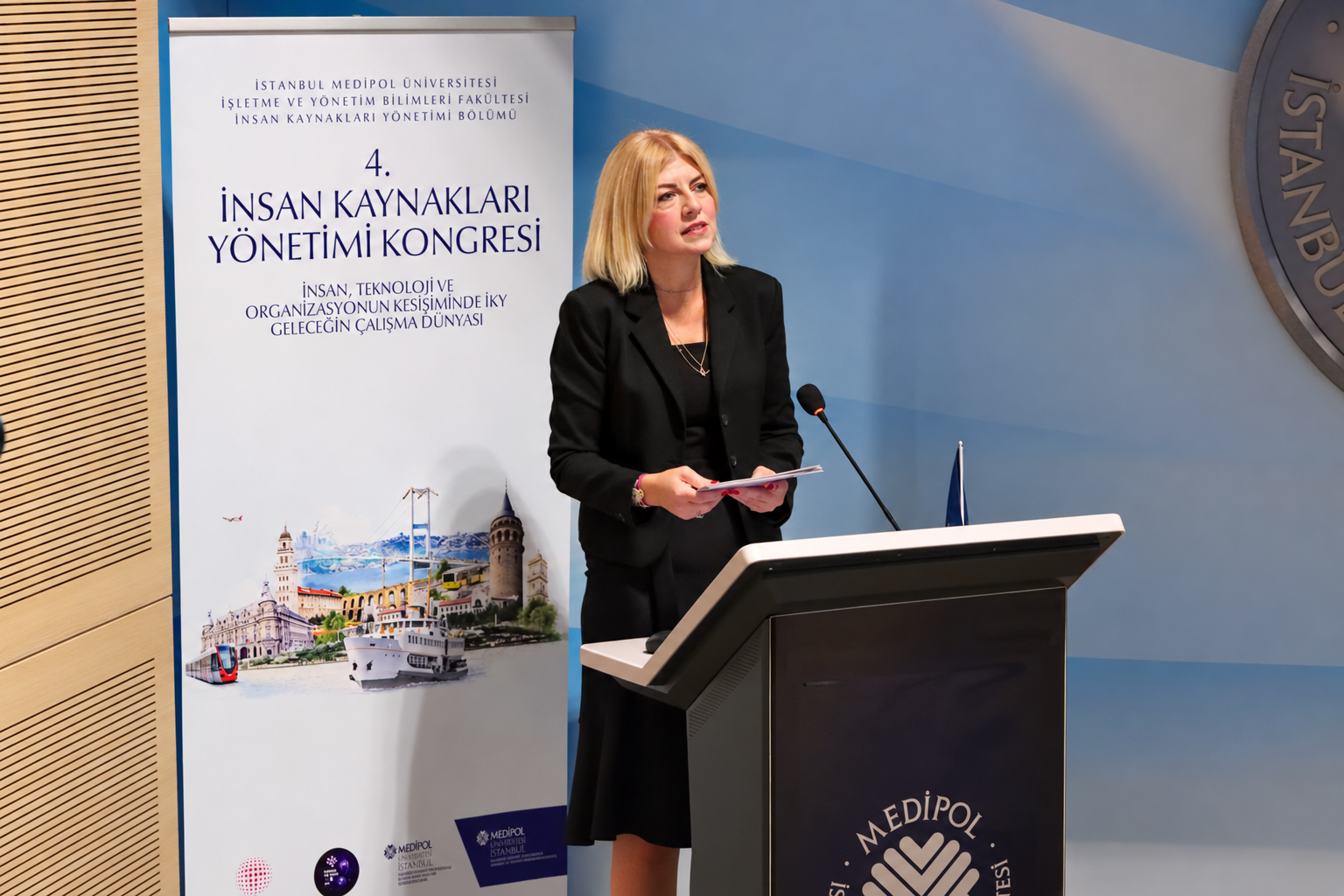 Woman speaking at a university podium